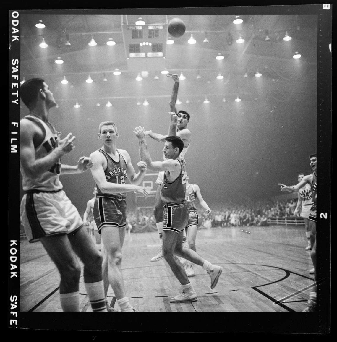 UNC’s Lennie Rosenbluth shoots over Wake Forest during action in the 1957 ACC Tournament in a smoky Reynolds Coliseum.
