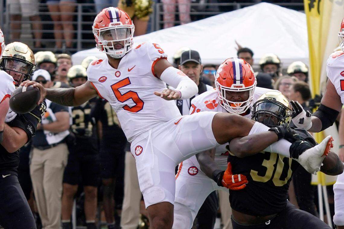Clemson quarterback DJ Uiagalelei (5) looks to pass as Wake Forest defensive lineman Jasheen Davis (30) tries to tackle him during their game in Winston-Salem, N.C., Saturday, Sept. 24, 2022.