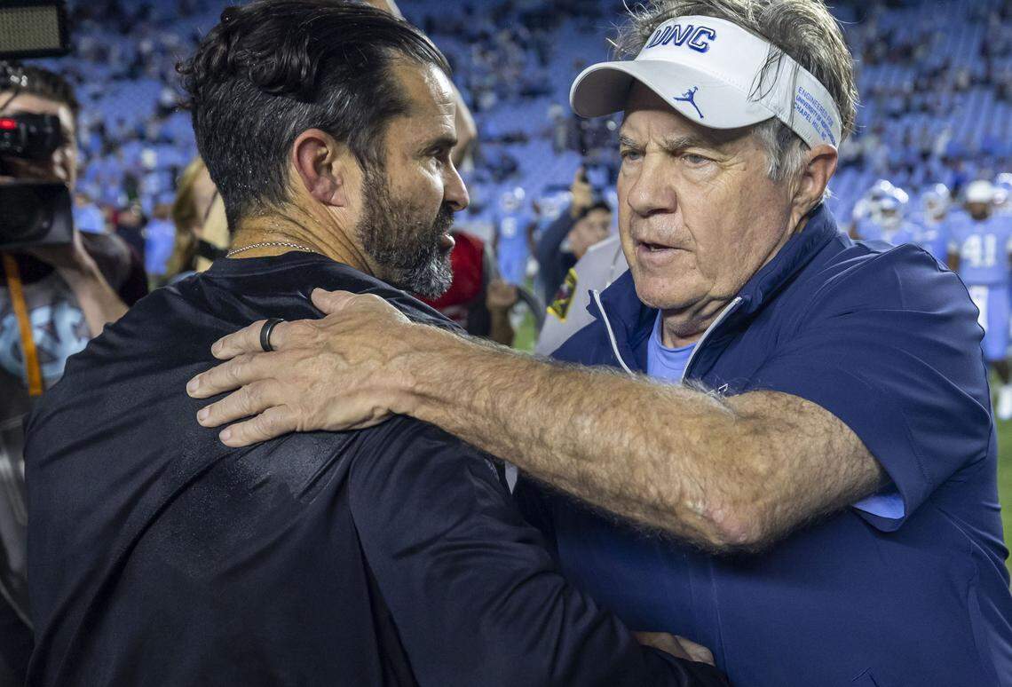 North Carolina coach Bill Belichick embraces Duke coach Manny Diaz following the Blue Devils’ 32-25 victory on Saturday, November 22, 2025 at Kenan Stadium in Chapel Hill, N.C.