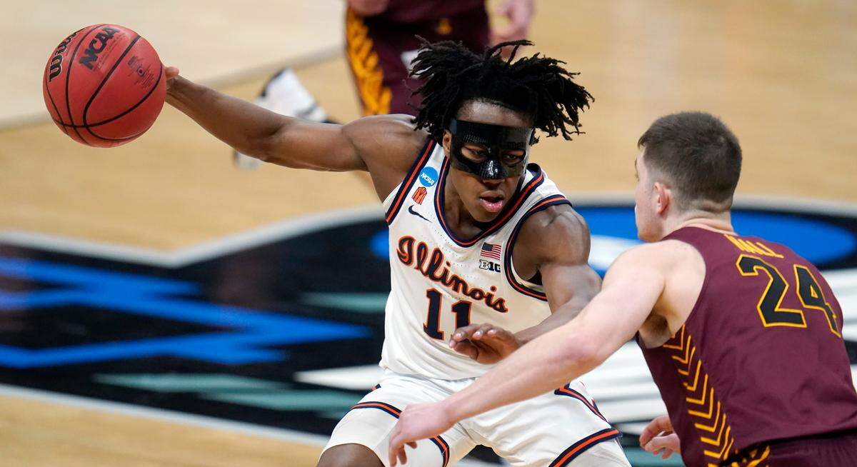 Illinois guard Ayo Dosunmu (11) drives on Loyola Chicago guard Tate Hall (24) during the first half of a men’s college basketball game in the second round of the NCAA tournament at Bankers Life Fieldhouse in Indianapolis, Sunday, March 21, 2021. 