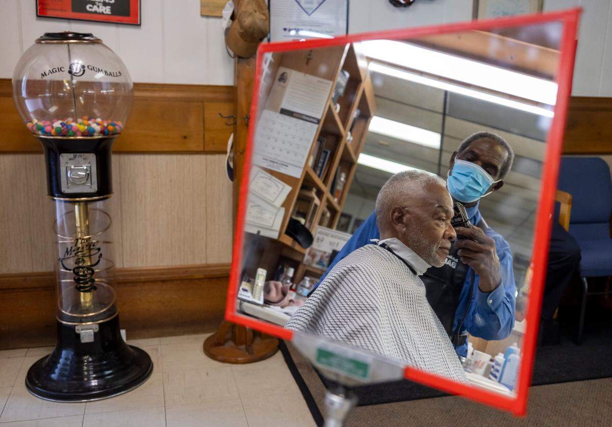 Willie Stevens gets his hair cut by Sylvester White at White’s Barber Shop on Thursday, May 15, 2025, in Raleigh, N.C.