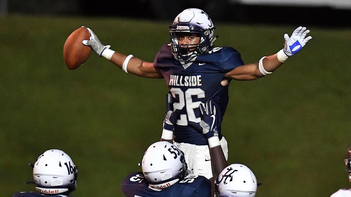 Hillside’s Jimmyll Willams (26) celebrates with teammates after scoring the touchdown in the second half against Rolesville. The Durham Hillside Hornets and the Rolesville Rams met in a football game in Durham, N.C. on September 9, 2022.