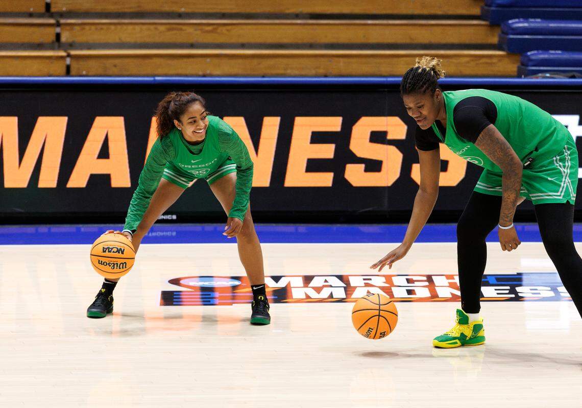 Oregon’s Deja Kelly smiles as she runs drills with teammate Phillipina Kyei during practice at Cameron Indoor Stadium on Thursday, March 20, 2025, in Durham, N.C. Kelly transferred to Oregon this season after playing four seasons at North Carolina. The Ducks will face Vanderbilt in the first round of the NCAA Tournament on Friday.
