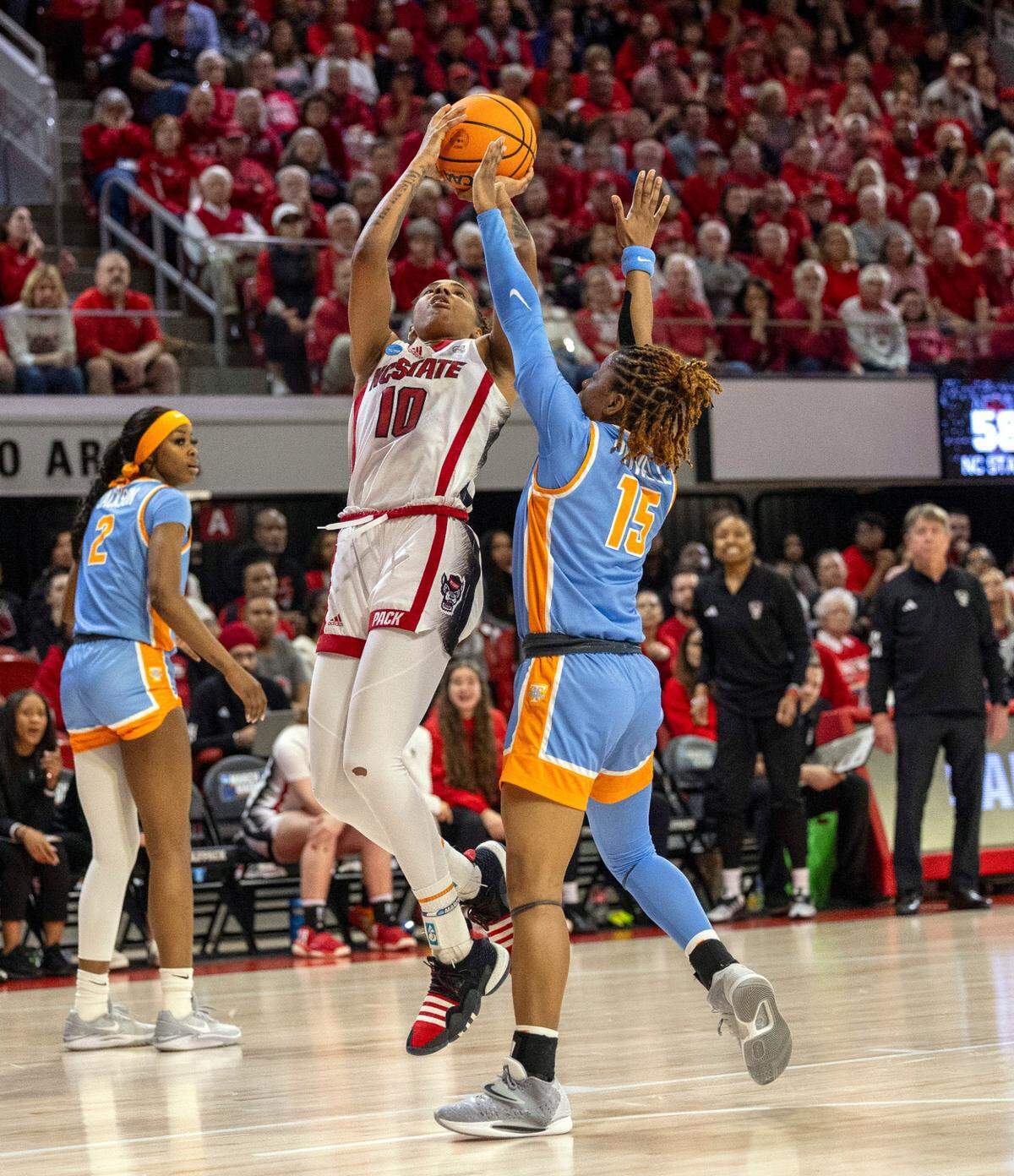 NC State’s Aziaha James (10) shoots as Tennessee’s Jasmine Powell (15) defends during the second round of the Division I Women’s Basketball Championship at Reynolds Coliseum in Raleigh, on March 25, 2024.