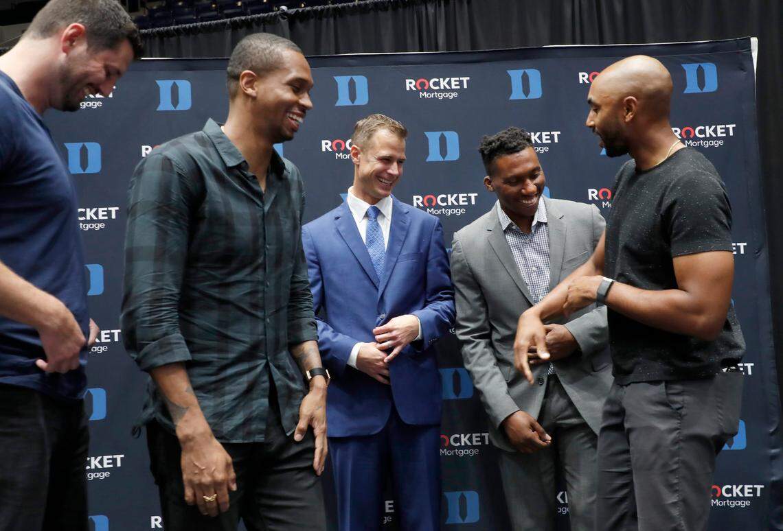 Jon Scheyer, center, laughs after posing with former teammates from left, Brian Zoubek, Lance Thomas, Nolan Smith and Gerald Henderson after Scheyer was introduced as Duke basketball’s 20th head coach during a press conference at Cameron Indoor Stadium in Durham, N.C., Friday, June 4, 2021.