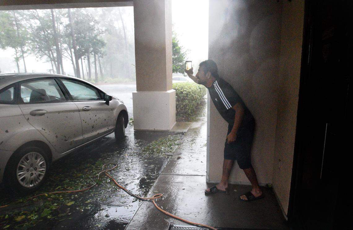 Benjamin Landero tries to shoot video as hurricane-force winds pound the Comfort Suites in Wilmington, N.C., Friday, Sept. 14, 2018, as Hurricane Florence makes landfall..