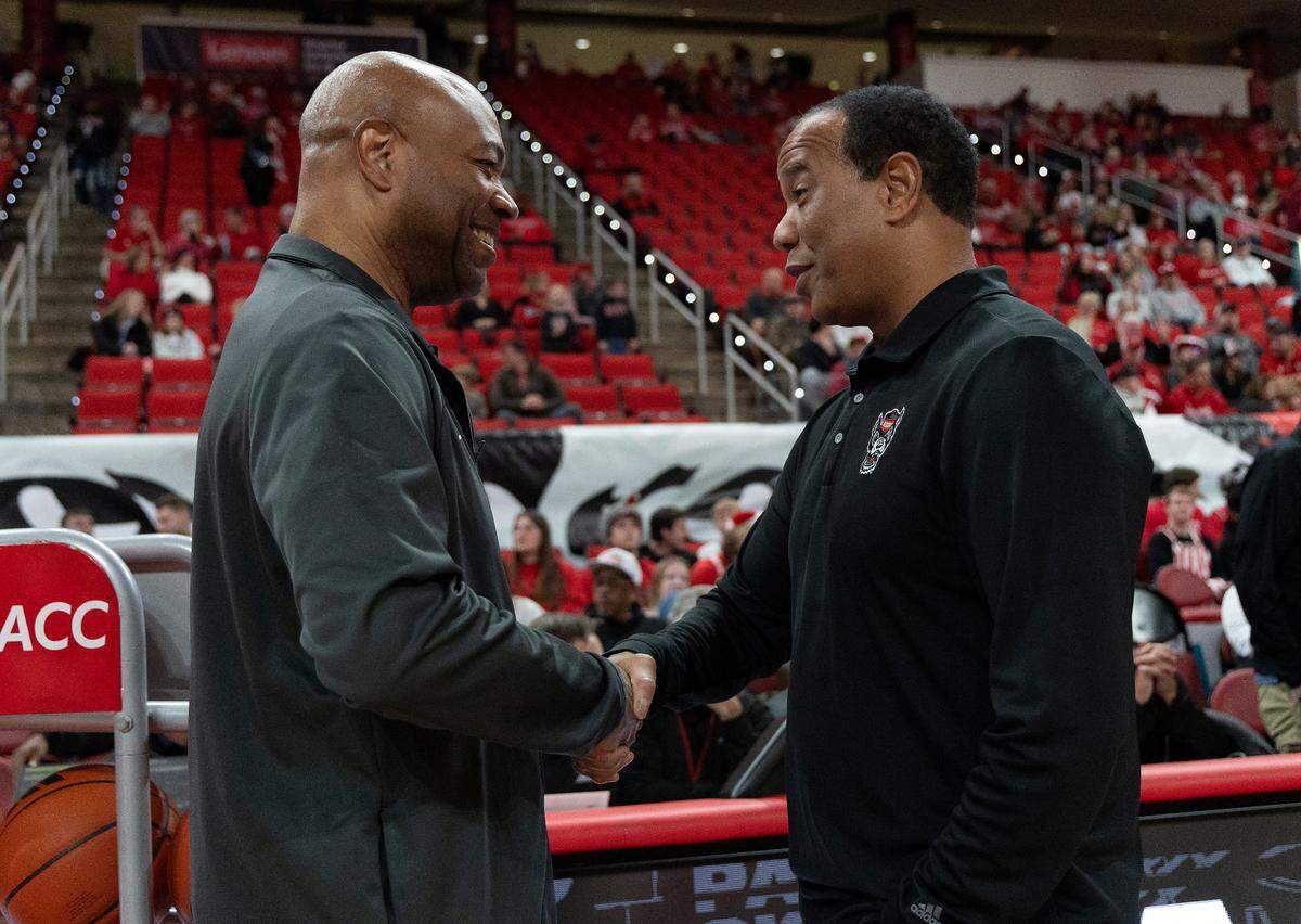 N.C. State head coach Kevin Keatts greets Florida State head coach Leonard Hamilton prior to the Wolfpack’s game against the Seminoles on Saturday, Dec. 7, 2024, at Lenovo Center in Raleigh, N.C.
