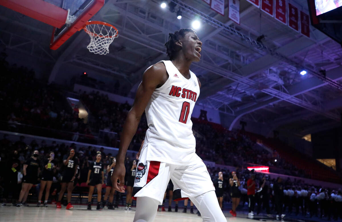 N.C. State’s Terquavion Smith (0) celebrates after making a slam during Primetime with the Pack at Reynolds Coliseum in Raleigh, N.C., Thursday, October 14, 2021.