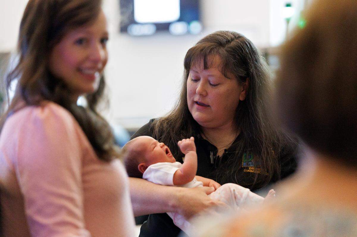 Chatham County 911 operator Lorie Teague meets with Sarah Gianni and her two-week-old daughter, Daisy, on Friday, April 25, 2025, at the Chatham County Emergency Operations Center in Pittsboro, N.C. Teague helped deliver Daisy over the phone on April 11.