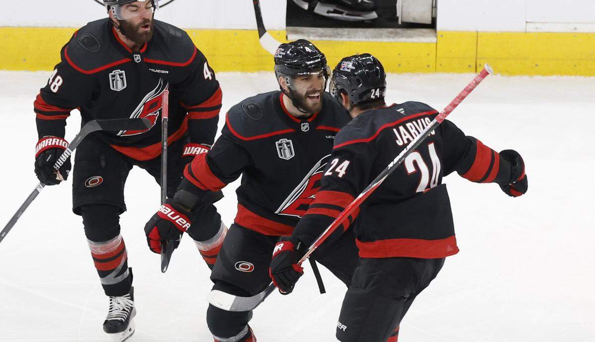 Carolina's Shayne Gostisbehere (4) celebrates with Seth Jarvis (24) after he scored in overtime of the Hurricanes’ 4-3 victory over the Golden Knights in the second game of the Stanley Cup Final at the Lenovo Center in Raleigh, N.C., Thursday, June 4, 2026.