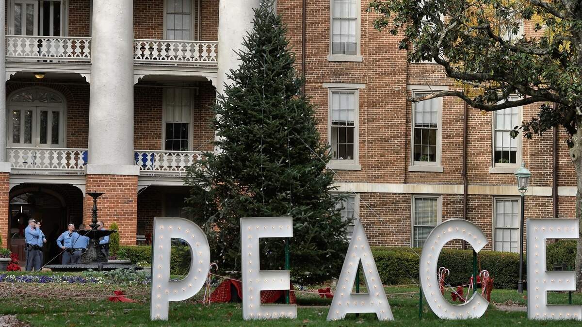 Raleigh police officers (lower left) stand outside the Main Residence Hall on the campus of William Peace University after a suicide threat has led to a lockdown at William Peace University on Monday, Dec. 3, 2018.