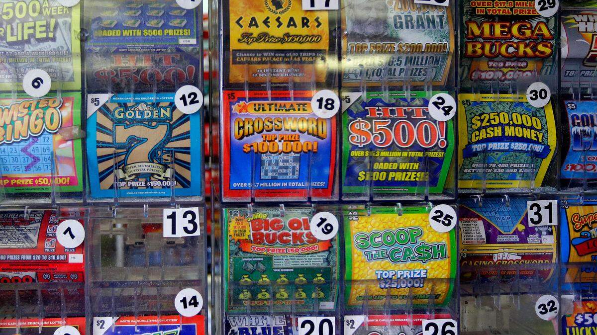 In this Thursday, July 17, 2014 photo, scratch-off lottery tickets for sale are on display at Eagles Express in Knightdale, N.C.
