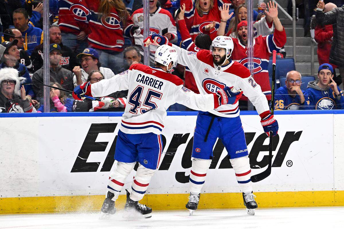 Alexandre Carrier (45) of the Montréal Canadiens celebrates a goal with teammate Phillip Danault during the third period against the Buffalo Sabres in Game 2 of the second round of the 2026 Stanley Cup Playoffs at KeyBank Center on May 08, 2026 in Buffalo, New York.