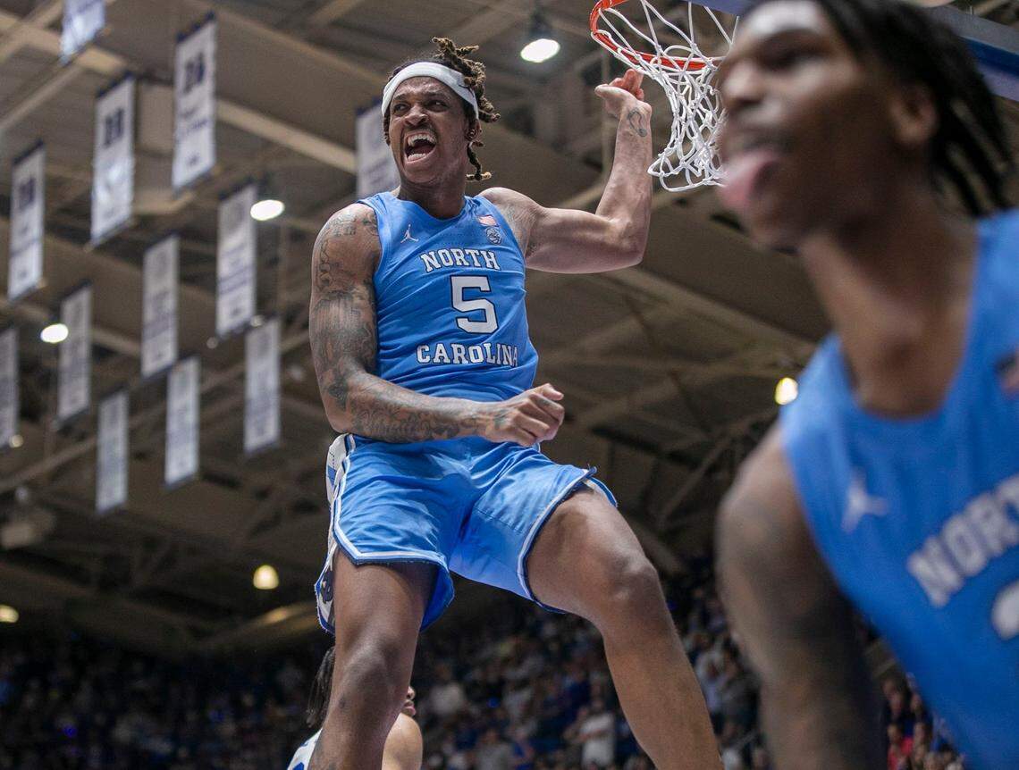 North Carolina’s Armando Bacot (5) and Caleb Love (2) react after a Bacot dunk to give the Tar Heels a commanding 86-76 lead over Duke with :56 seconds to play on Saturday, March 5, 2022 in Durham, N.C. Bacot lead the Tar Heels with 23 points.