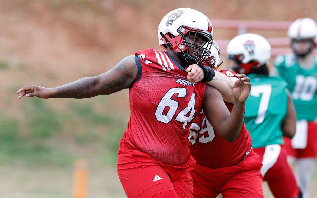 N.C. State offensive lineman Rico Jackson (64) runs drills during the Wolfpack’s first spring practice in Raleigh, N.C., Wednesday, March 1, 2023.