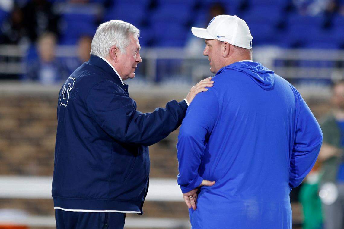 North Carolina Tar Heels head coach Mack Brown speaks with Duke Blue Devils head coach Mike Elko prior to the game on Saturday, Oct. 15, 2022, at Wallace Wade Stadium in Durham, N.X.