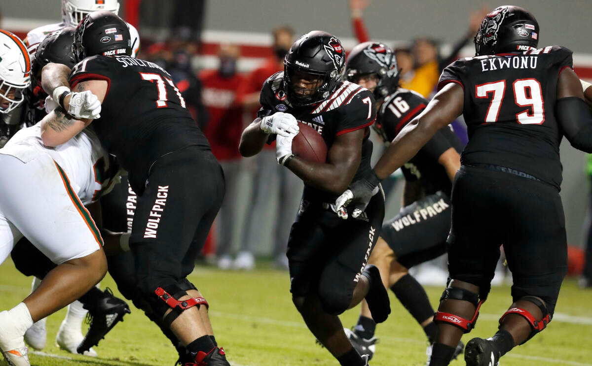 N.C. State running back Zonovan ‘Bam’ Knight (7) scores on a one-yard touchdown run without his shoe during the second half of Miami’s 44-41 victory over N.C. State at Carter-Finley Stadium in Raleigh, N.C., Friday, Nov. 6, 2020.