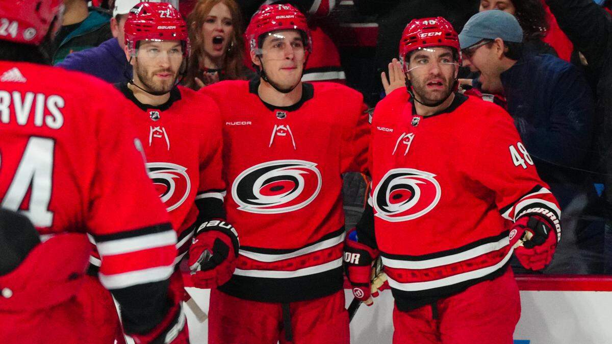 Jan 11, 2024; Raleigh, North Carolina, USA; Carolina Hurricanes defenseman Brady Skjei (76) celebrates his goal with defenseman Brett Pesce (22) and left wing Jordan Martinook (48) against the Anaheim Ducks during the first period at PNC Arena. Mandatory Credit: James Guillory-USA TODAY Sports