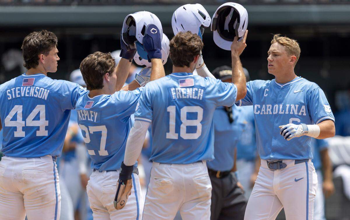 North Carolina second baseman Jackson Van De Brake (6) is greeted at home after a 3 RBI home run in the third inning to take a 3-1 lead over Arizona during the NCAA Super Regional final on Sunday, June 8, 2025 at Boshamer Stadium in Chapel Hill, N.C.