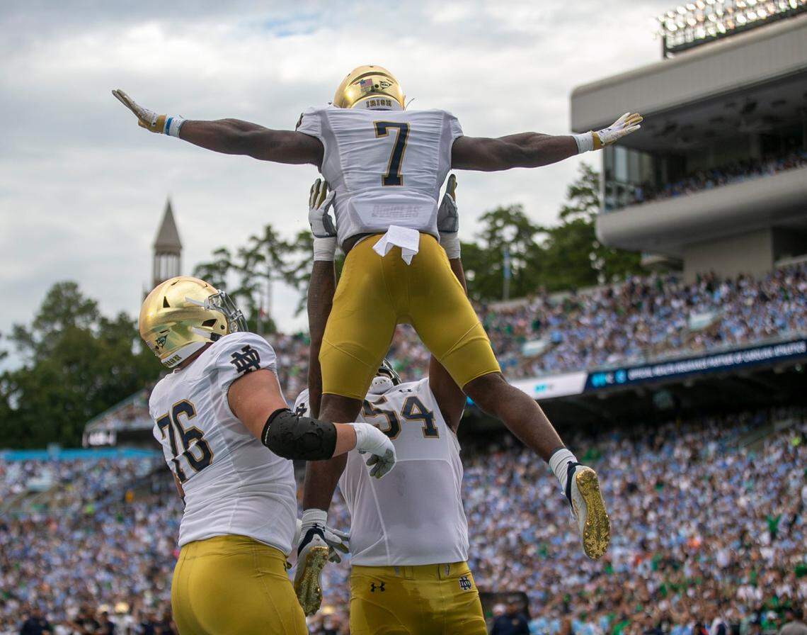 Notre Dame’s Audric Estime (7) celebrates with Jacob Lacey (54) and Joe Alt (76) after scoring a touchdown on a one-yard run to give the Irish a 21-14 lead over North Carolina in the second quarter on Saturday, September 24, 2022 at Kenan Stadium in Chapel Hill, N.C.