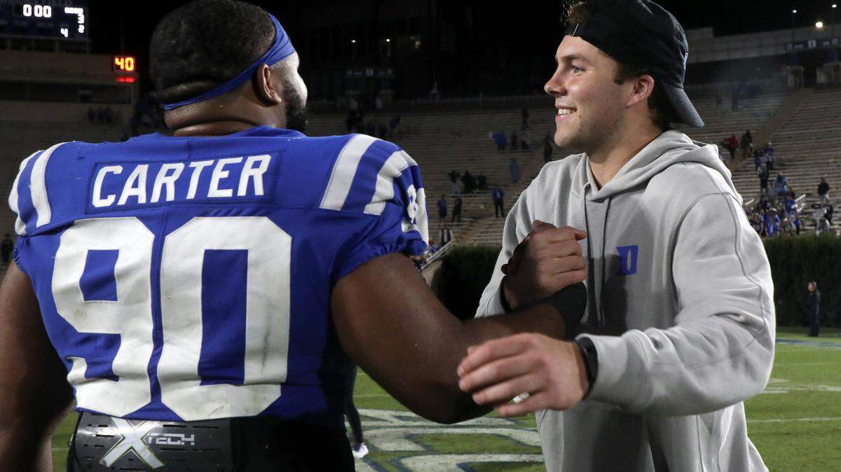Duke’s Riley Leonard congratulates teammate DeWayne Carter following the Blue Devils’ 24-3 win over N.C. State on Saturday, Oct. 14, 2023, at Wallace Wade Stadium in Durham, N.C.