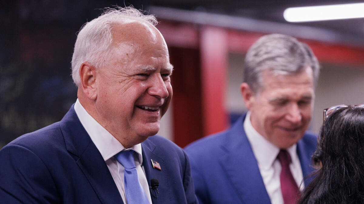 Democratic Vice Presidential nominee and Minnesota Gov. Tim Walz smiles during a visit to a campaign office with Gov. Roy Cooper in Raleigh, N.C. on Thursday, Aug. 29, 2024.