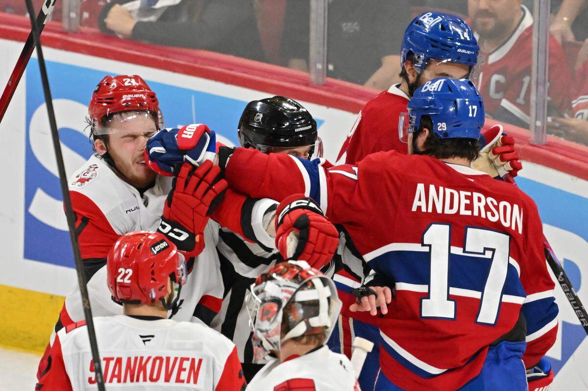 Alexander Nikishin #21 of the Carolina Hurricanes and Josh Anderson #17 of the Montreal Canadiens get into an altercation during the second period in Game Four of the Eastern Conference Final of the 2026 Stanley Cup Playoffs at Bell Centre on May 27, 2026 in Montreal, Quebec, Canada. 