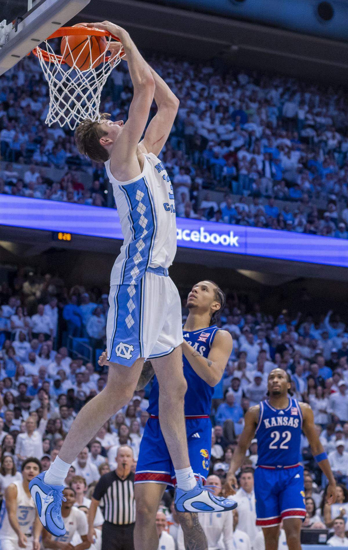 North Carolina center Henri Veesaar (13) reverse dunks over Kansas guard Tre White (3) in the second half on Friday, November 7, 2025 at the Smith Center in Chapel Hill, N.C.