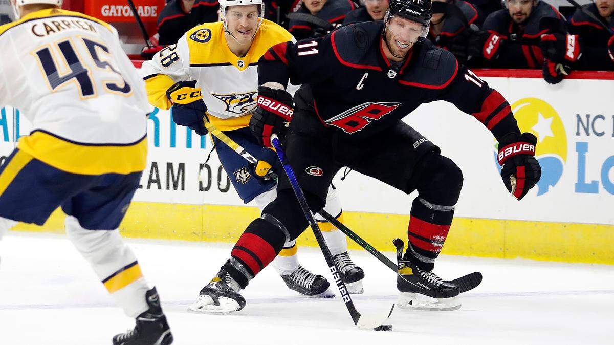 Carolina Hurricanes’ Jordan Staal (11) splits the defense of Nashville Predators’ Alexandre Carrier (45) and Eeli Tolvanen (28) during overtime in an NHL hockey game in Raleigh, N.C., Tuesday, March 9, 2021. (AP Photo/Karl B DeBlaker)