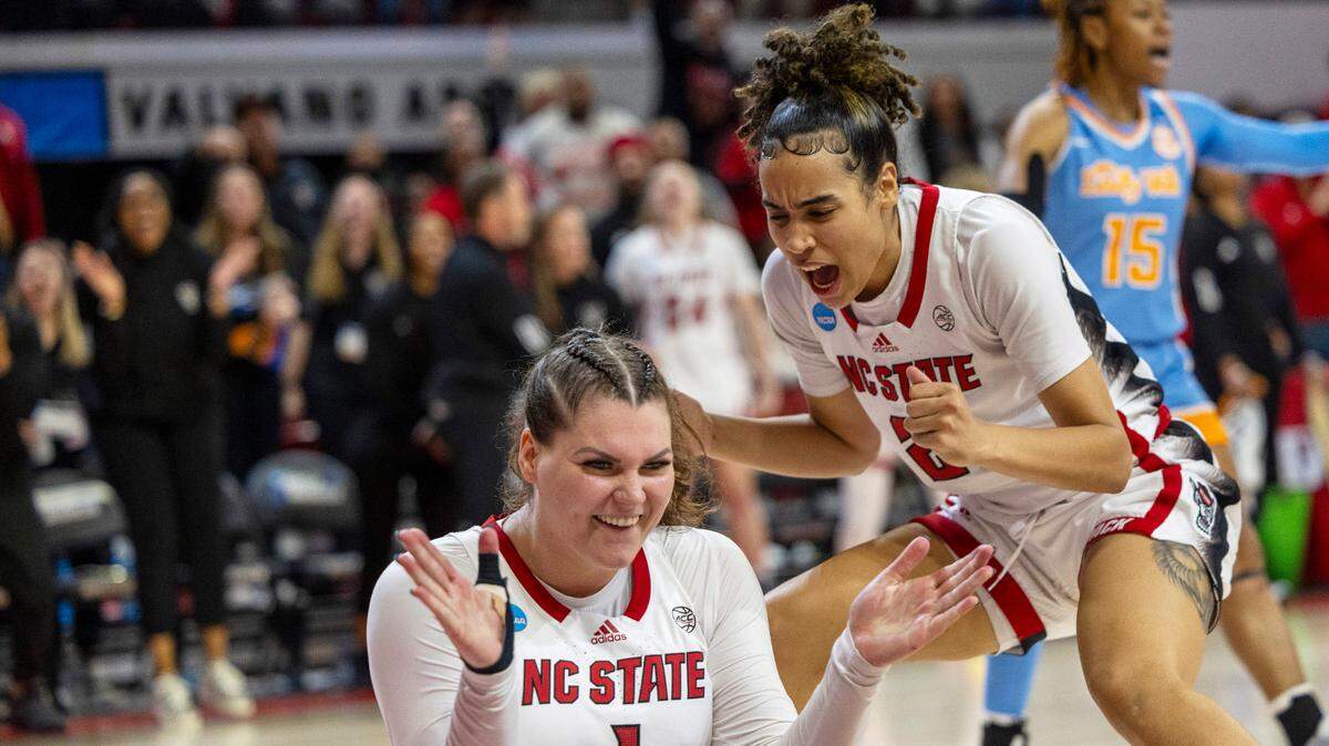 NC State’s River Baldwin (1) and Madison Hayes (21) celebrate after Baldwin was fouled after scoring two late in the second half against Tennessee’s during the second round of the Division I Women’s Basketball Championship at Reynolds Coliseum in Raleigh, North Carolina, on March 25, 2024.