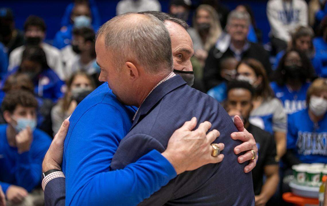 Duke coach Mike Krzyzewski embraces Elon head coach Mike Schrage prior to the game on Saturday, December 18, 2021 at Cameron Indoor Stadium in Durham, N.C.