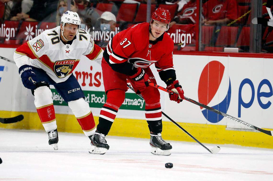 Carolina Hurricanes Andrei Svechnikov (37) and Florida Panthers Patric Hornqvist (70) eye the puck during the first period of an NHL hockey game in Raleigh, N.C., Tuesday, April 6, 2021. (AP Photo/Karl B DeBlaker)