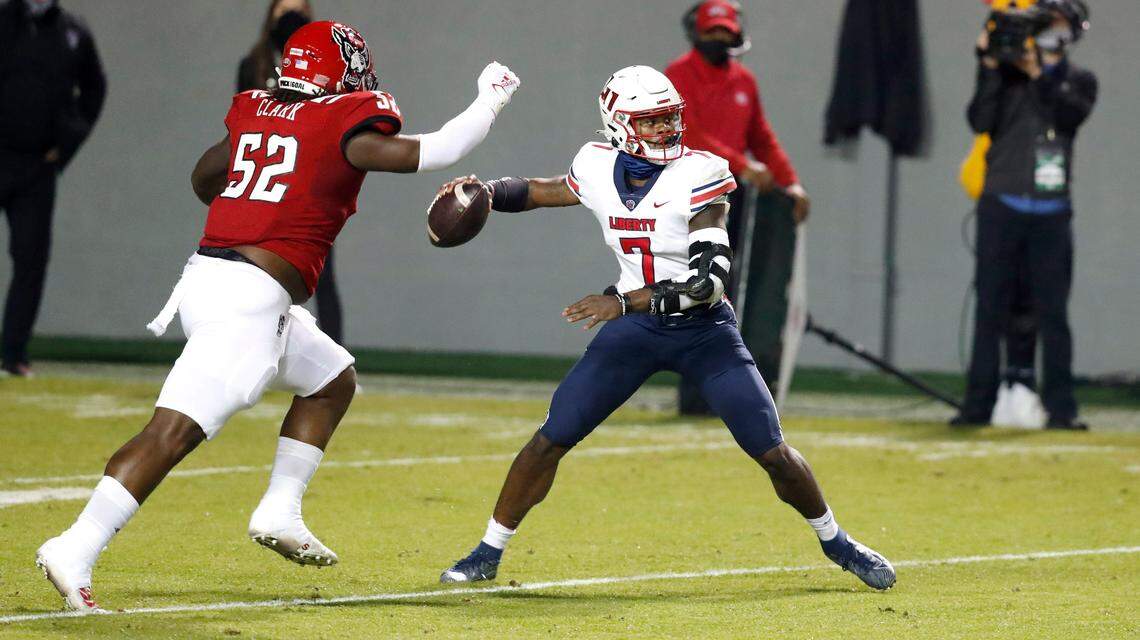 Liberty quarterback Malik Willis (7) prepares to pass as N.C. State defensive tackle C.J. Clark (52) closes in during the first half of N.C. State’s 15-14 win over Liberty at Carter-Finley Stadium in Raleigh, N.C., Saturday, Nov. 21, 2020.