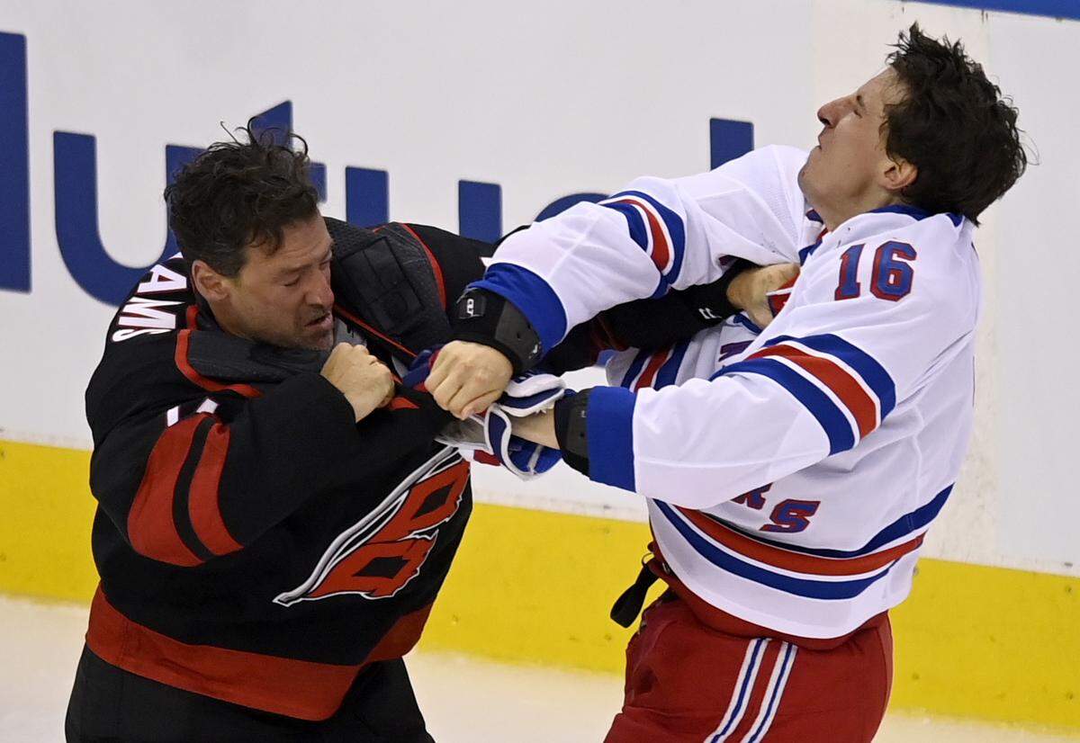 New York Rangers’ Ryan Strome (16) fights with Carolina Hurricanes’ Justin Williams during the first period in the NHL hockey Stanley Cup playoffs in Toronto, Saturday, Aug. 1, 2020. (Frank Gunn/The Canadian Press via AP)