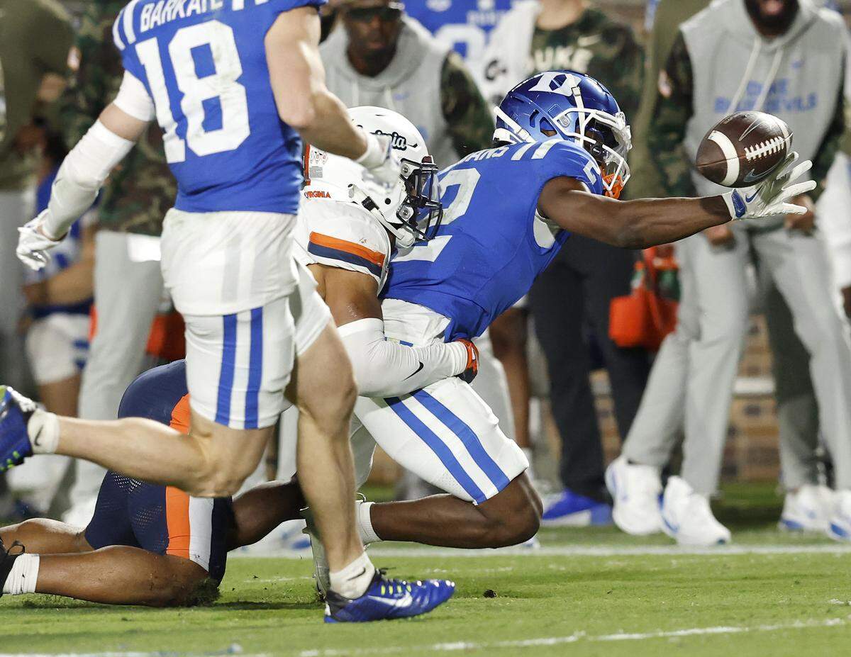 Duke’s Sahmir Hagans fumbles the ball after being hit by Virginia’s Donavon Platt during the second half of the Blue Devils’ 34-17 loss on Saturday, Nov. 15, 2025, at Wallace Wade Stadium in Durham, N.C. 