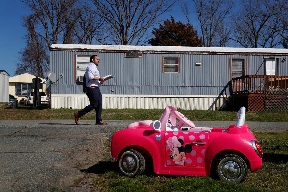 Ricky Hurtado, a Democratic candidate for the North Carolina state house, walks past a child’s toy car as he canvasses in a largely Latino trailer community, in Burlington, N.C., Sunday, March 8, 2020.
