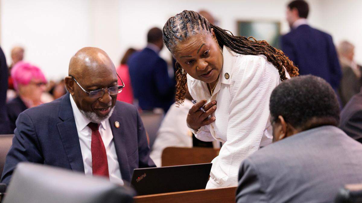 Reps. Shelly Willingham, Carla Cunningham and Garland Pierce talk during a break in session in the House chamber of the Legislative Building on Wednesday, May 21, 2025, in Raleigh, N.C.
