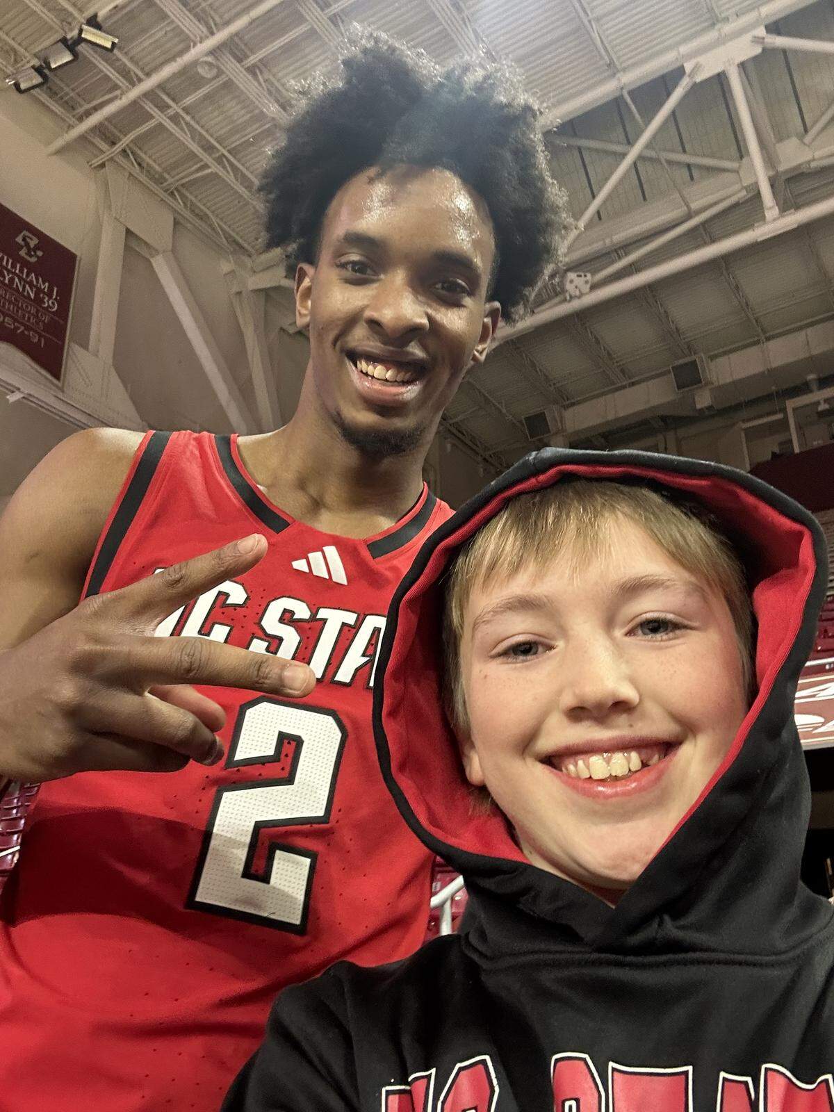 N.C. State’s Paul McNeil takes a selfie with Finley Hall ahead of the Wolfpack’s men’s basketball game at Boston College on Jan. 6, 2026, in Chestnut Hill, Mass.