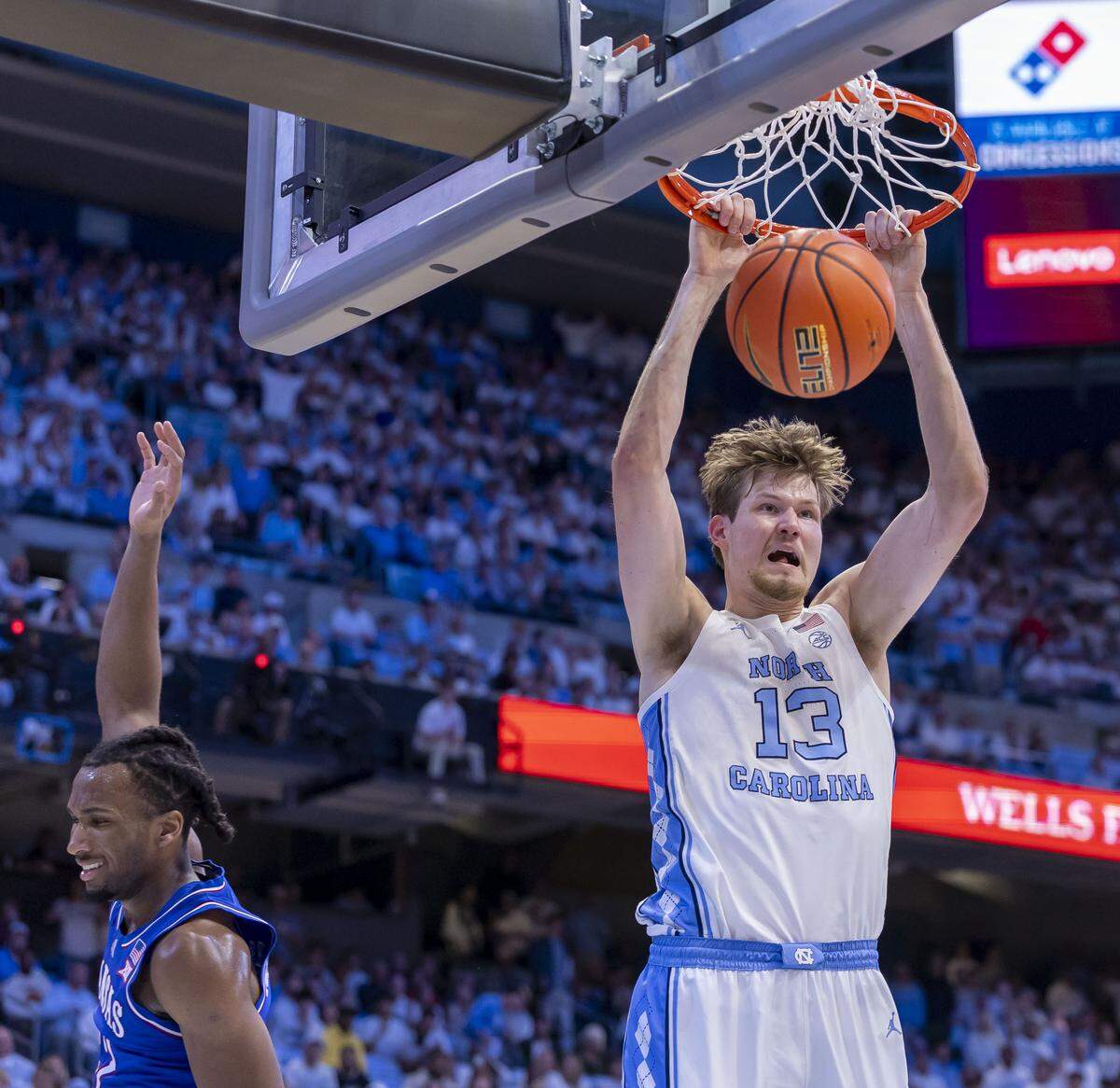 North Carolina center Henri Veesaar (13) dunks over Kansas guard Darryn Peterson (22) in the first half on Friday, November 7, 2025 at the Smith Center in Chapel Hill, N.C.