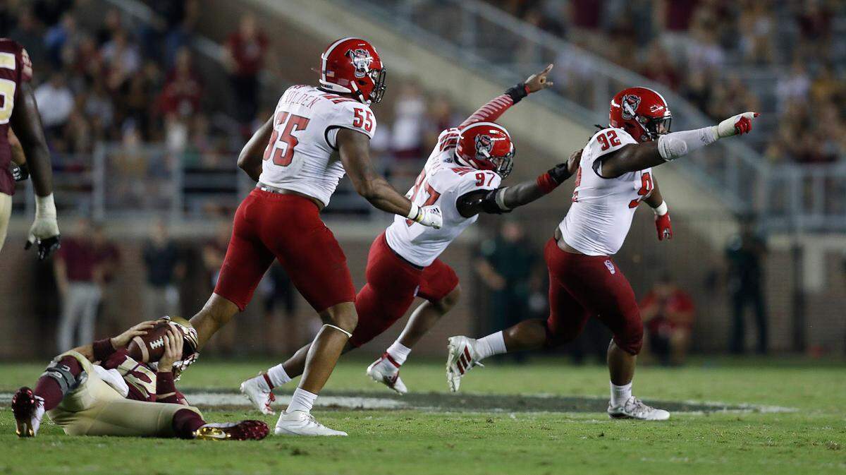 N.C. State’s Larrell Murchison (92) and Xavier Lyas (97) celebrate after Florida State quarterback Alex Hornibrook (12) was sacked during the second half of Florida State’s 31-13 victory over N.C. State at Doak Campbell Stadium in Tallahassee, Fla., Saturday, Sept. 28, 2019.