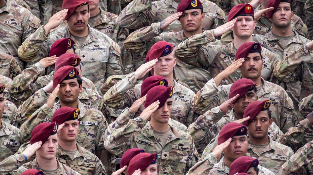 Soldiers salute during the national anthem at Fort Bragg at a ceremony marking the U.S. Army’s 250th anniversary.