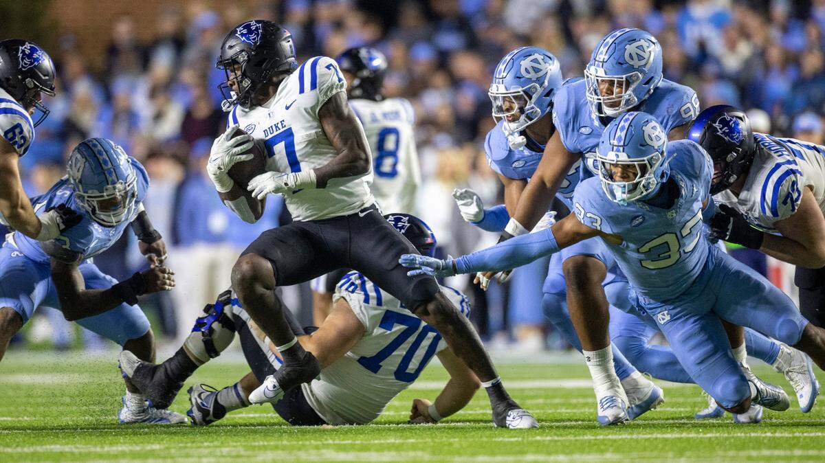 Duke’s Jordan Waters (7) slips away from North Carolina’s Cedric Gray (33) in the third quarter on Saturday, Nov. 11, 2023 at Kenan Stadium in Chapel Hill, N.C. Waters rushed for 113 yards in the game.