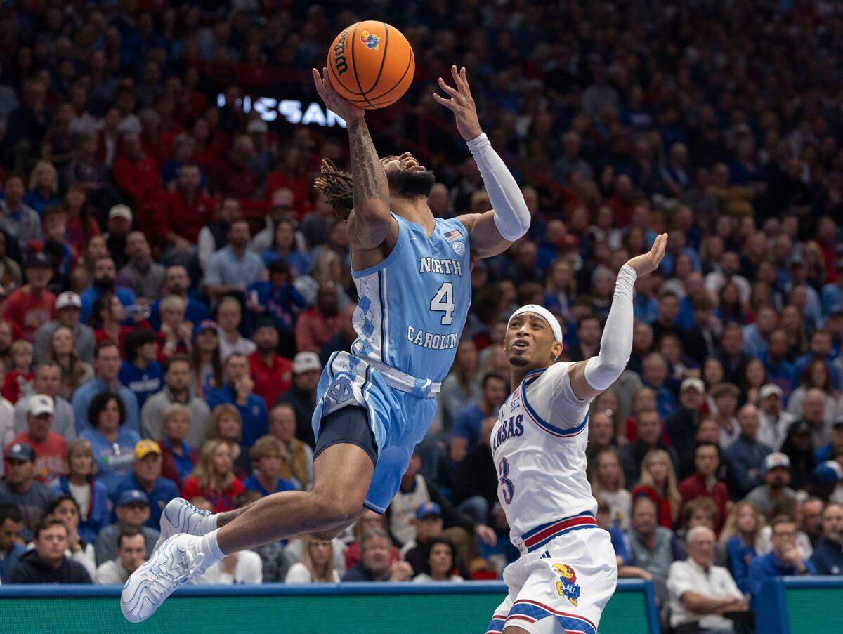 North Carolina guard R.J. Davis (4) drives to the basket against Kansas’ Dajuan Harris Jr (3) in the first half on Friday, November 8, 2024 at Allen Fieldhouse in Lawrence, Kansas.