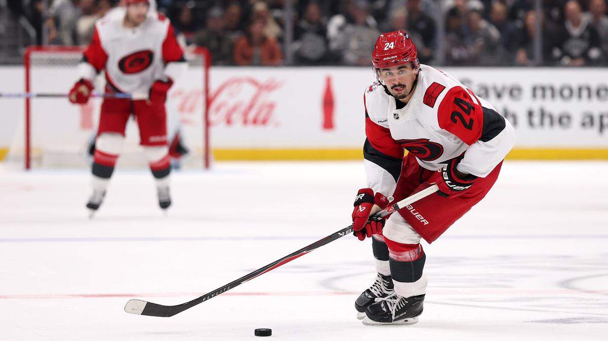 Seth Jarvis of the Carolina Hurricanes skates with the puck against the Los Angeles Kings during the third period at Crypto.com Arena on October 18, 2025 in Los Angeles, California. Jarvis went down injured Thursday against the Islanders after taking two pucks off the left foot.