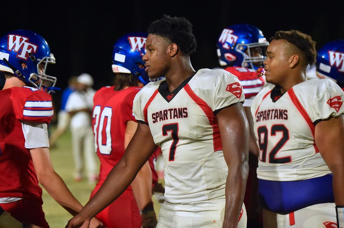 Southern Durham’s Jaybron Harvey (7), in his teams loss, congratulates the Wake Forest players. The Wake Forest Cougars and the Southern Durham Spartans met in a football game in Wake Forest, N.C. on August 19, 2022.