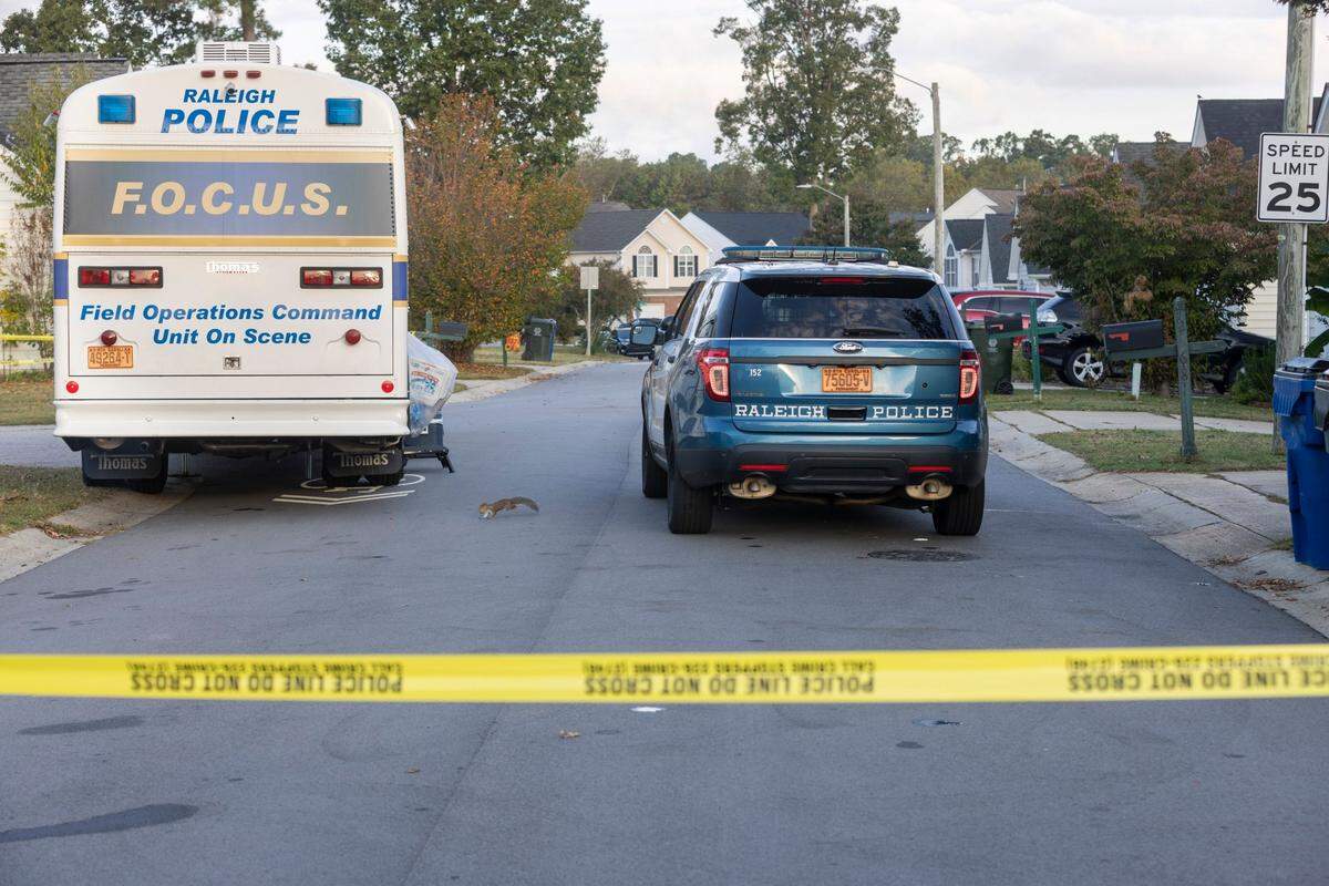 Raleigh Police have blocked Sahalee Way and Castle Pines Drive in the Hedingham neighborhood on Friday morning, October 14, 2022 in Raleigh, N.C. as they continue to investigate the killing of five people yesterday on the greenway nearby.