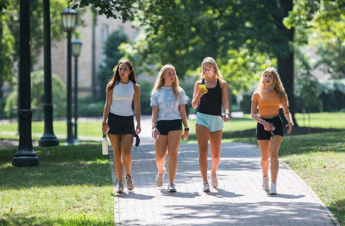 From left, Rachel Kivlan, Grace Rotan, Peyton Thomas and Anna Tarlton, all first year students at UNC-Chapel Hill, walk through McCorkle Place in Chapel Hill, N.C. on Thursday, Aug. 12, 2021.