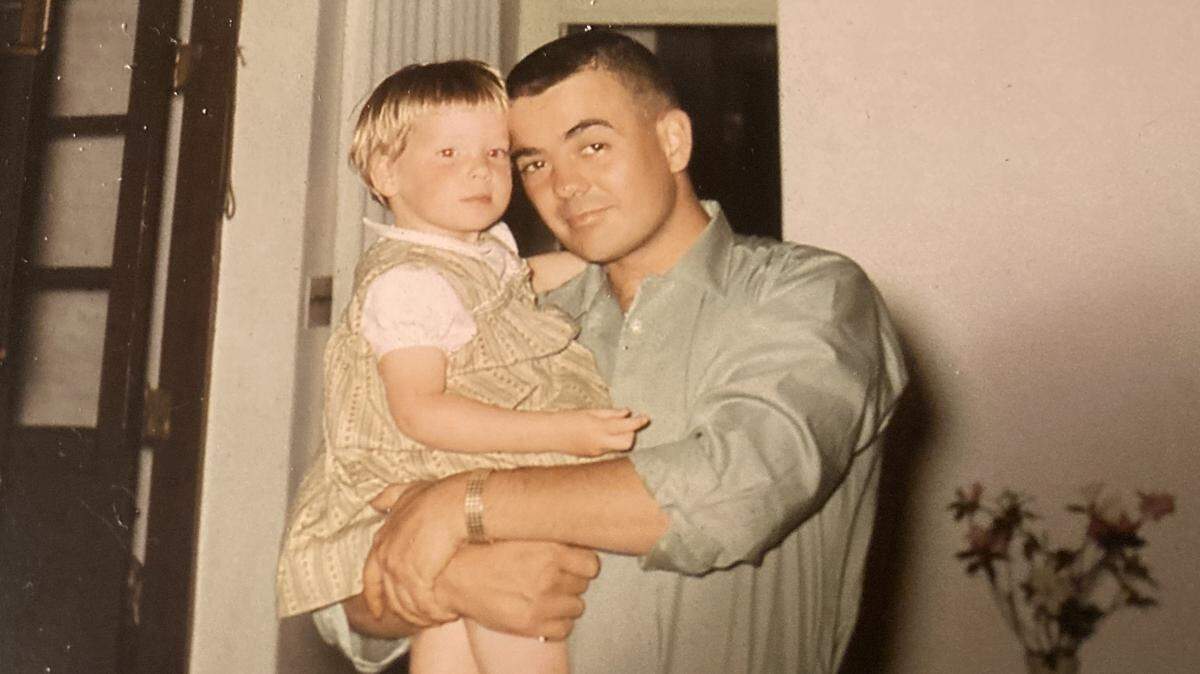 Capt. Hugh R. Nelson Jr. holds one of his three children in this photo provided by the U.S. Army. Nelson, who grew up in North Carolina, was awarded the Medal of Honor for saving the lives of three fellow soldiers at the cost of his own in Vietnam in 1966.