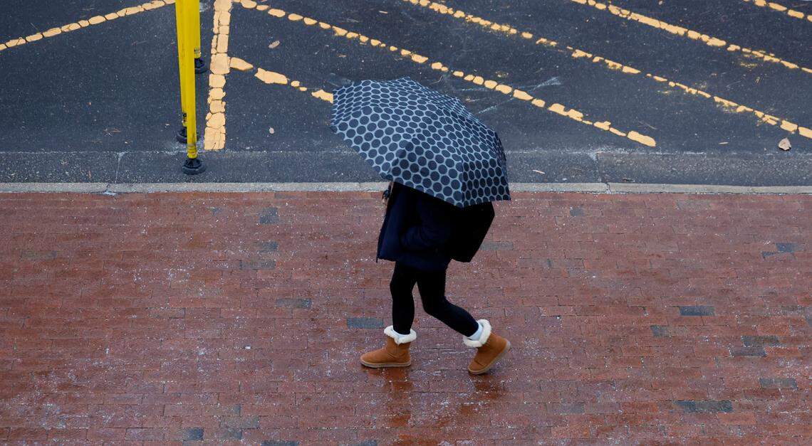 An umbrella offers protection as sleet falls as seen on Dunn Ave. on the campus of N.C. State in Raleigh, N.C., Friday, Jan. 10, 2025.
