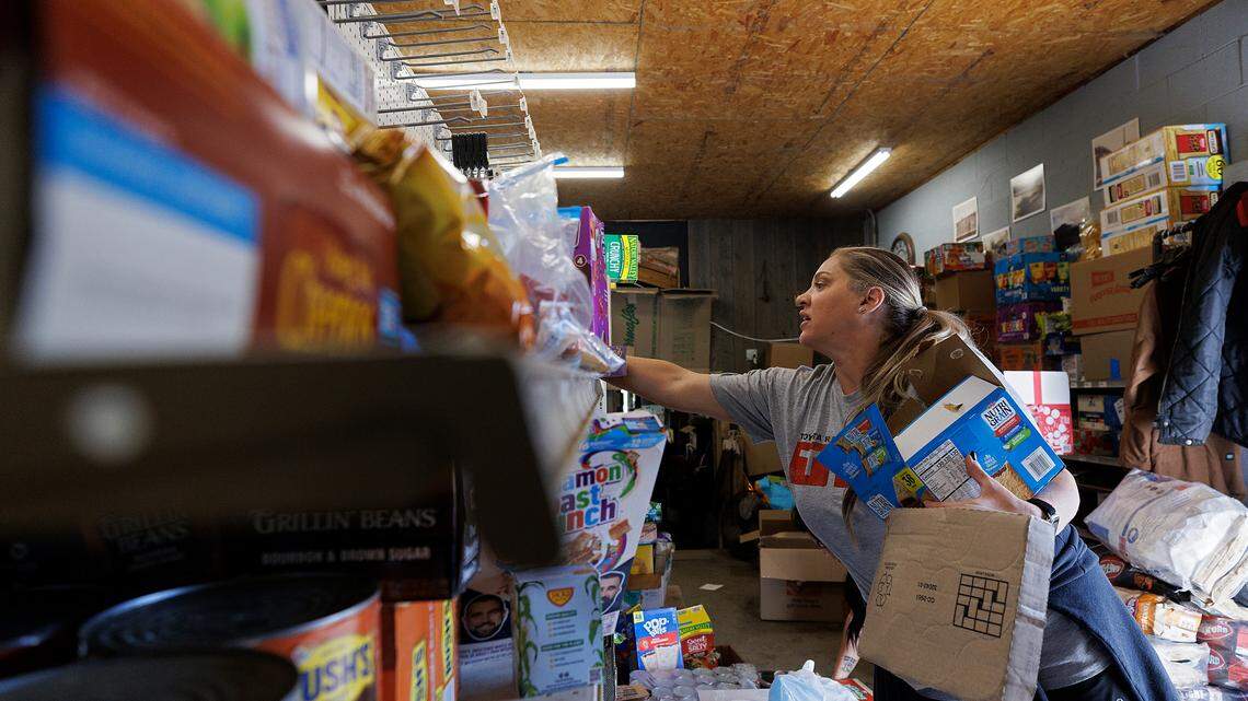 Jaimie Goddard, a volunteer from Charlotte, N.C., organizes donated supplies at Spear Country Store & Hardware on Thursday, Oct. 3, 2024, in Newland, N.C., days after Hurricane Helene brought heavy flooding to the region.
